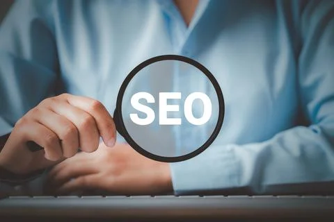 SEO Search Engine Optimization, Woman holding through magnifying glass with t Foto stock