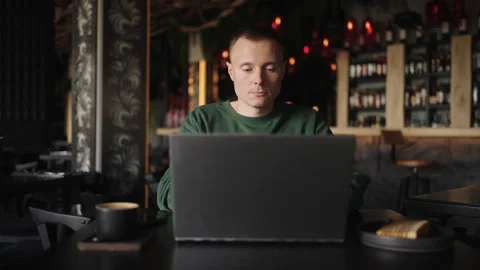 SEO Specialist Or Web Developer Working Remotely With Laptop In Cafe, Frontal Stock Footage 246025346