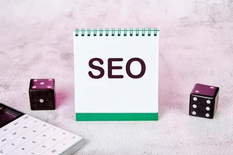 Seo text on a notepad standing on the table is an open Notebook With An Seo.. Stock Photos