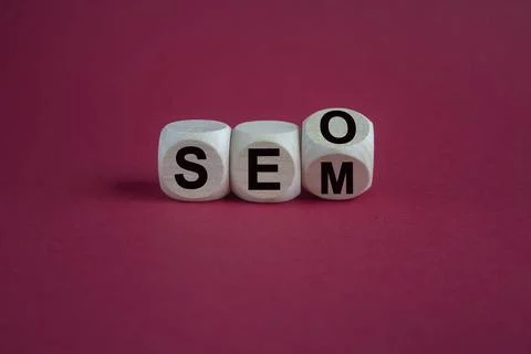 SEO versus SEM. Turned a cube and changed the expression SEO to SEM Stock Photos