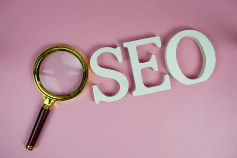Seo words (Search Engine Optimization) letters with magnifying glass on pin.. 写真素材