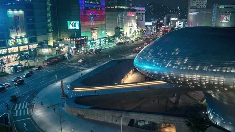 Seoul - Elevated city view with traffic and Dongdaemun Design Plaza at night. 4K Stock Footage 80190485