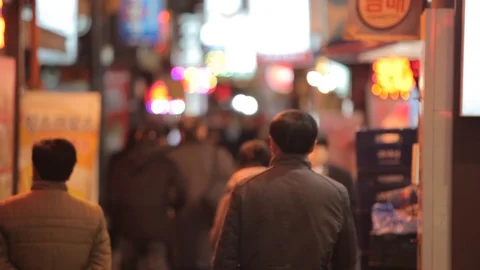 Seoul sci fi street with glowing signs and pedestrians pull focus Stock Footage 100596124