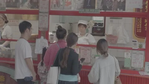 SEP.14.2026.CHINA.A customer at the snack stall counter. Stock Footage 345470393