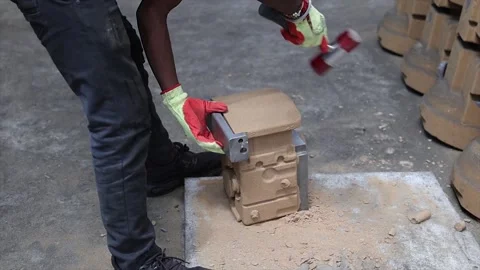 Separate and clean a sand mold during the metal casting process in a foundry Stock Footage 321798308