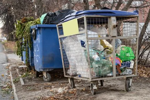 Separate collection of garbage in containers on a city street for recycling Stock Photos