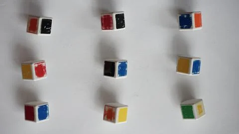 Separate elements of a rubik's cube on a white surface Foto stock