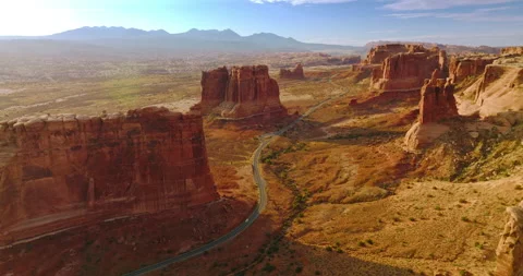 Separate mount standing lonely on the desert land. Motorway going among the rock Stock Footage 212947536