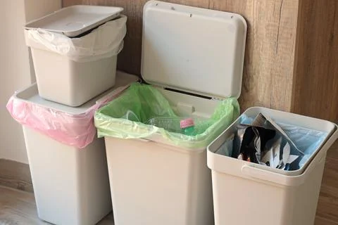 Separate sorting of garbage at home. Colorful bags and containers. Ecology and Stock Photos