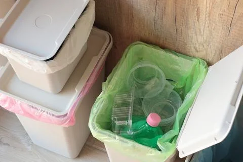 Separate sorting of garbage at home. Colorful bags and containers. Ecology and Stock Photos
