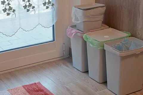 Separate sorting of garbage at home. Colorful bags and containers. Ecology and Stock Photos