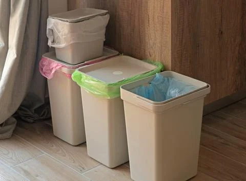 Separate sorting of garbage at home. Colorful bags and containers. Ecology and Fotos Stock