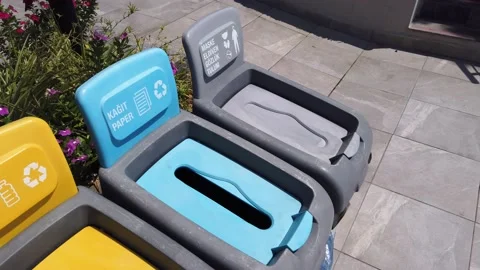 Separate waste collection concept. Plastic cups are thrown into the yellow bi Video stock 167208657