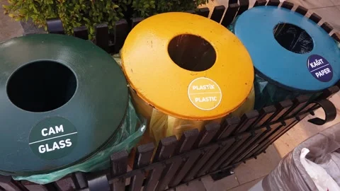 Separate waste collection concept. Plastic cups are thrown into the yellow bi Video stock 171108340