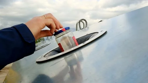 Separate waste sorting. A man's hand puts an glass jar into a metal trash can. Stock Footage 166597196