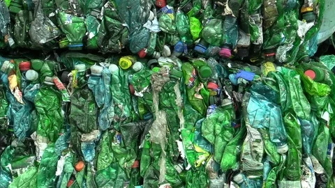 Separated and pressed waste green plastic bottles package ready for recycling Stock Footage 89603499