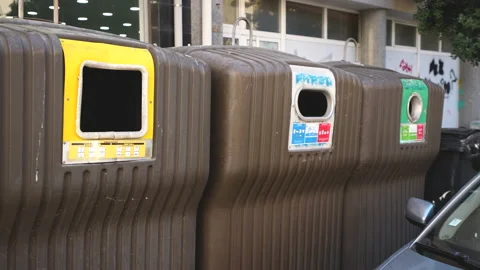 Separated garbage disposing bins. Plastic cans for glass, metal, paper, organics Stock Footage 166543952