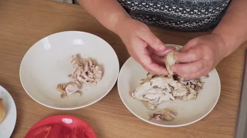 Separating chicken meat from bones for Ukrainian borscht. Cleaning cooked Stock Footage 316045302