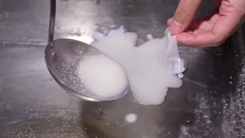Separating the solidified film from the liquid Stock Footage 317138237