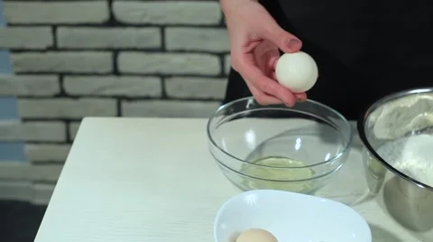 Separating yolk and white of the white shell egg with woman hands  Stock Footage 68909035