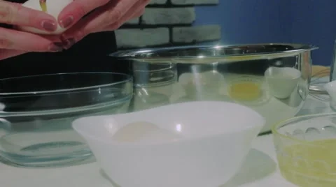 Separating yolk and white of the white shell egg with woman hands  Stock Footage 68909041