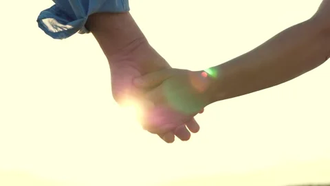Separation two loving people. sunset through fingers. sign symbol goodbye Stock Footage 247499486