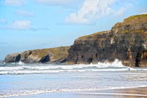 Sepia soft waves breaking on the high cliffs Stock Photos
