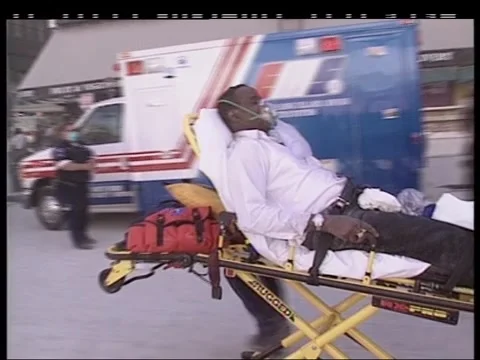 September 11, 2001, Paramedics caring for wounded man on stretcher trolley Stock Footage