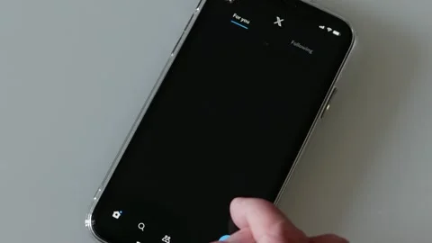 SEPTEMBER 12, 2023: Using New X App, previously known as Twitter, on an iPhone Stock Footage 250091850