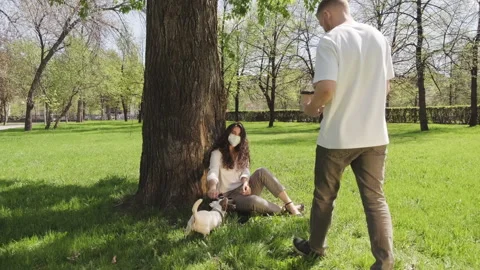 Sequence of Couple in Face Masks Relaxing in Park on Summer Day 動画素材 133759664