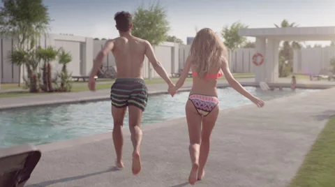 Sequence of a couple playing on a resort pool Stock Footage 65218950