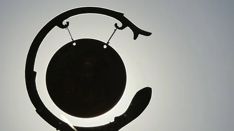 Sequence of gong hits against sun silhouette Stock Footage 71199548