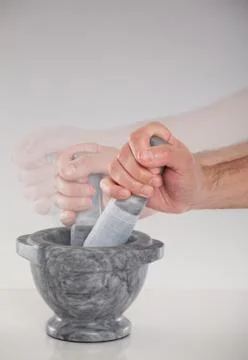 Sequence of a hand using a mortar and pestle Stock Photos