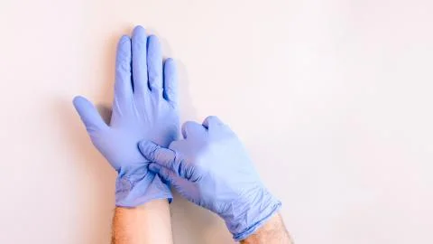Sequence of images in which a man's hands taking off blue disposable gloves m Stock Photos