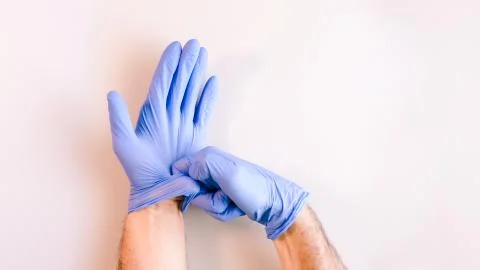 Sequence of images in which a man's hands taking off blue disposable gloves m Stock Photos