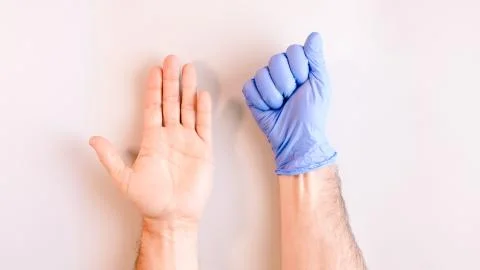 Sequence of images in which a man's hands taking off blue disposable gloves m Stock Photos