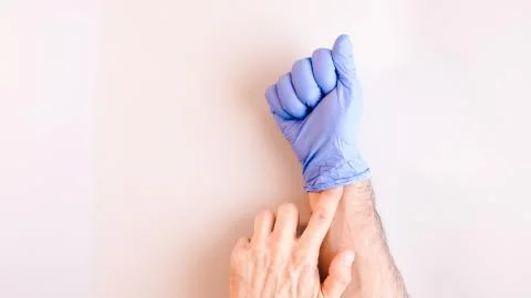 Sequence of images in which a man's hands taking off blue disposable gloves m Stock Photos