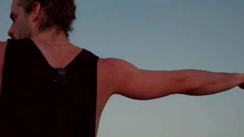 Sequence of Male Yogi Doing Warrior Pose on Cliff by Ocean at Sunset Stock Footage 157583010