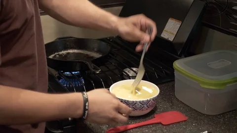 Sequence of Man Cooking Eggs and Woman Making Toast for Breakfast Stock Footage