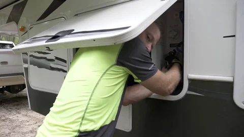 Sequence of Man Hooking up Water to RV Camper Stock Footage 80535401