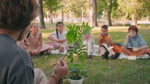 Sequence of Man Teaching Kids about Nature Outdoors 動画素材 138962704