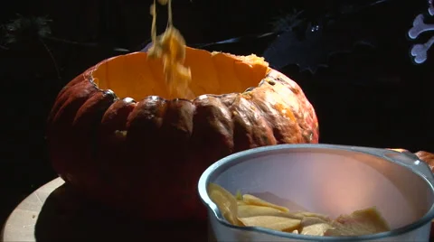Sequence scooping flesh and seeds from Halloween Pumpkin Stock Footage 67672589