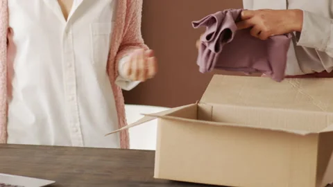 Sequence of Women Packing Clothes Order for Delivery Video stock 143000739