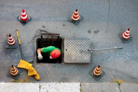 Sequence of worker going in the manhole in the street, step 5 Stock Photos