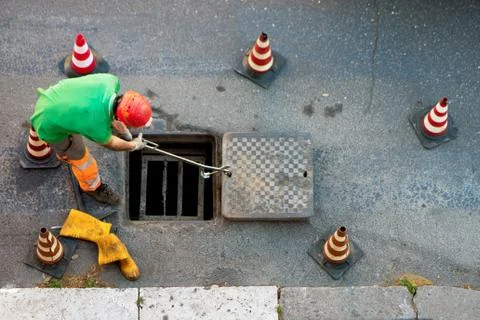 Sequence of worker going in the manhole in the street, step 7 Stock Photos