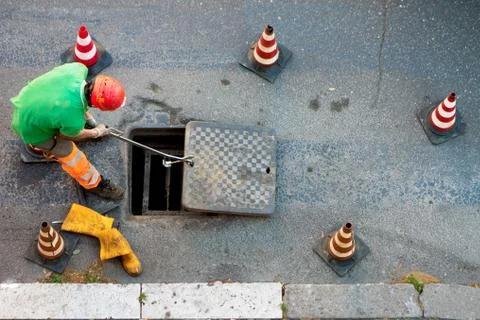 Sequence of worker going in the manhole in the street, step 8 Stock Photos