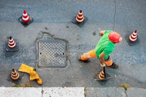 Sequence of worker going in the manhole in the street, step 9 Stock Photos