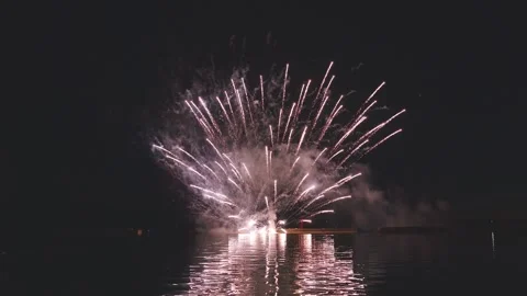 Sequential colorful fireworks display bursting vividly in dark night sky Stock Footage 340632797