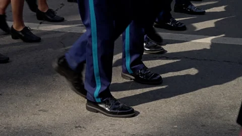 A sequential depiction of two distinct groups marching in formation, emphasizing Stock Footage 312675192