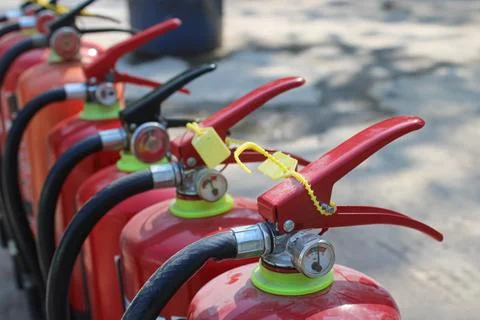 Sequential Row of Fire Extinguishers with Safety Seals Stock Photos